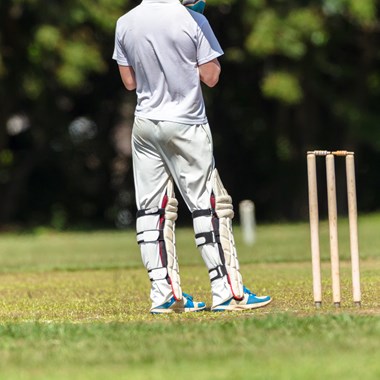 Gentleman waiting to play cricket standing next to wicket 